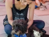 Palomar student Steph Santagio sits under Love on a Leash's canopy petting Daisy, a pet therapy dog used to help relievate the petters stress. This was just a part of Palomar College's Career Day held at the Student Union on April 27. Tracy Grassel/The Telescope