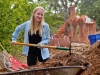 Madison Power, a STEM Ambassador, rakes mulch into a wheelbarrow at the Spring 2016 Arboretum Beautification Day on April 30. Michaela Sanderson/The Telescope.