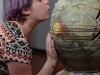 Gallery attendee Michelle Hauswirth blows into ceramic artist Jessica Rae Thompson's sculpture thereby creating a whistle sound during the Ceramics Biennial at the Palomar College Boehm Gallery on Feb. 18. Tracy Grassel/The Telescope