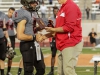 November 22, 2014 |Palomar quarterback #2 Mitch Bartram accepts the Most Valuable Player award from Palomar Athletic Director Scott Cathcart. Bartram finished the game with 222 yards passing and a touchdown, he also rushed for 31yards. The Comets went on to defeat the Vaqueros 30-22 and win the Patriotic Bowl at Escondido HS, in Escondido California.| Photo Credit: Philip Farry | The Telescope