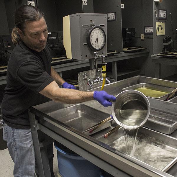 Chris Youngren in the photography lab. (Niko Holt/The Telescope)