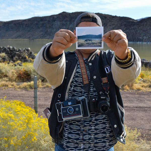 Photography student Irwin Sanchez holding one of his polaroids. Oct. 11, 2016. (Brianna Dice/The Telescope)