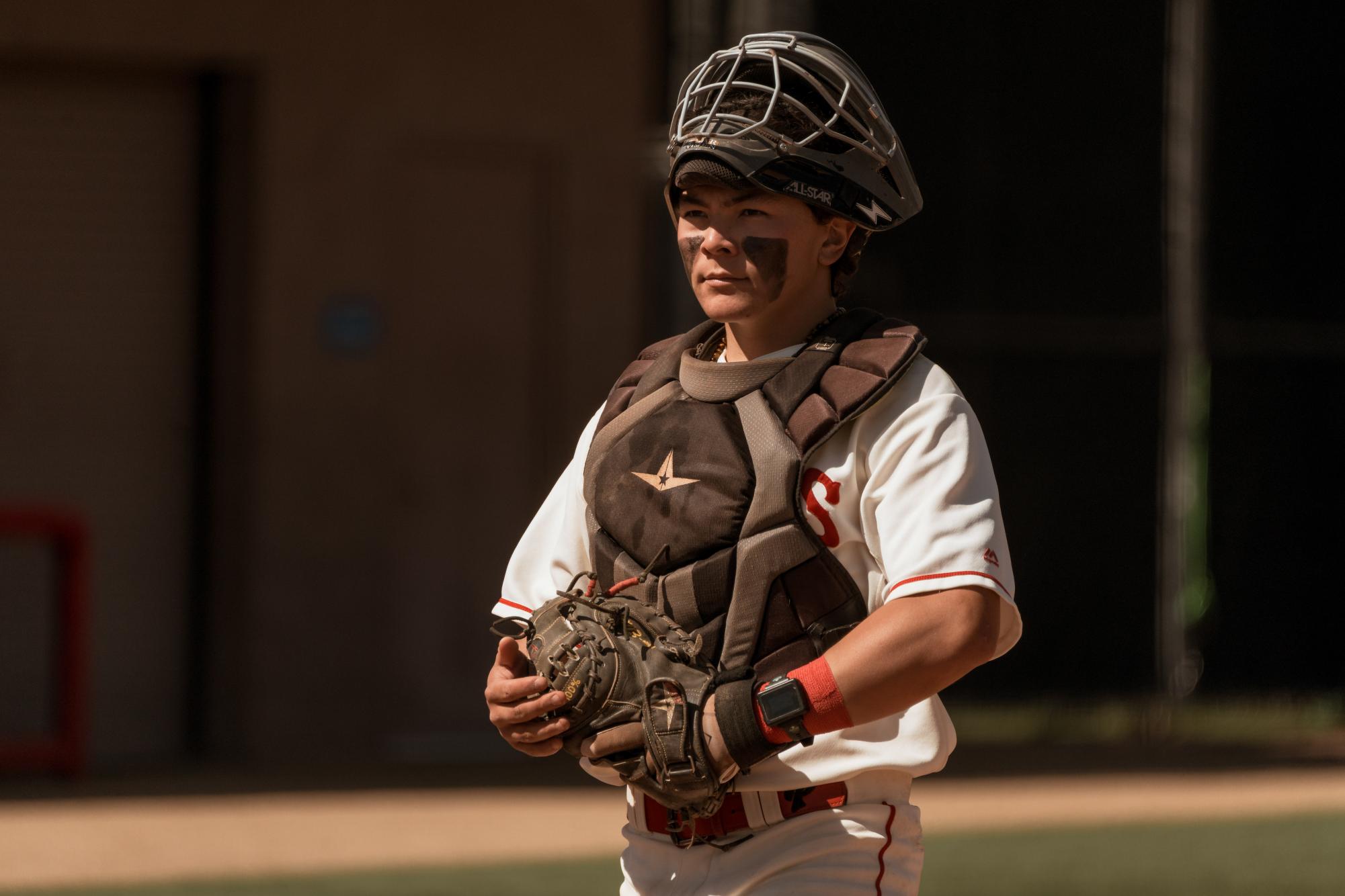 Carter Jorissen with his catching mask off in between a play.