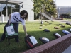 Sept. 12, 2013 | Shayla Fox sets backpacks with notes of the loves ones who lost a loved one to a suicide along side the brick wall at Palomar College | Phtoto Credit: Guillermo Escamilla/Copyright 2013 The Telescope
