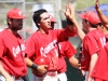 Palomar first baseman Eric Sapp gets congratulated by his teammates after scoring on second baseman Chris Stratton’s RBI groundout against Allan Hancock College in game 3 of the first round of the Southern California Regional baseball playoffs on May 3 at Myers Field. The Comets went on to lose the game 8-3, and the series to the Bulldogs in 3 games.• Scott Colson/The Telescope