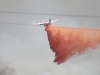 CalFire aircraft dropping fire retardant on a section of the San Marcos fire that is threatening business in the vicinity of Woodland Drive. Stephen Davis