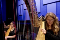 Rachel Starr Ellins (right), performs on harp as Tatum Chute (left) plays in the background during the HarpWaves concert at Palomar College’s free Concert Hour series in the Performance Lab on March 5.