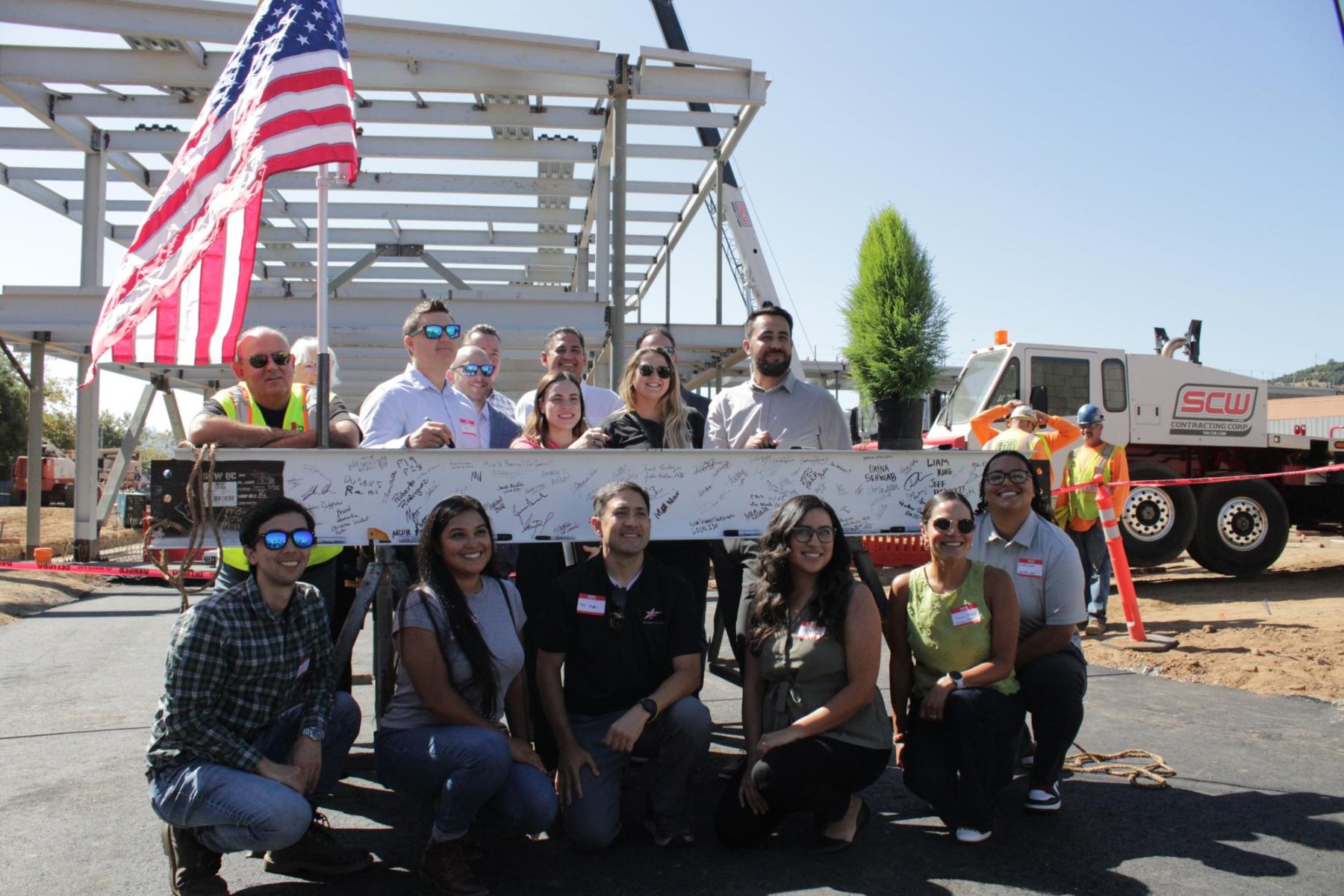 Fallbrook learning center staff and faculty pose with the beam at the beam signing ceremony at Palomar's Fallbrook campus on Oct.1.