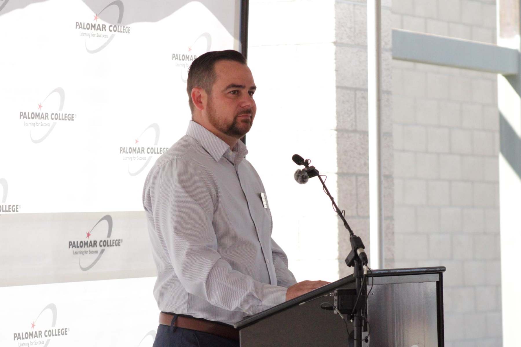 Ryan Williams makes a speech at the beam signing ceremony at Palomar's Fallbrook campus on October 1. Williams is the Education Center Director for the Fallbrook Palomar Campus.