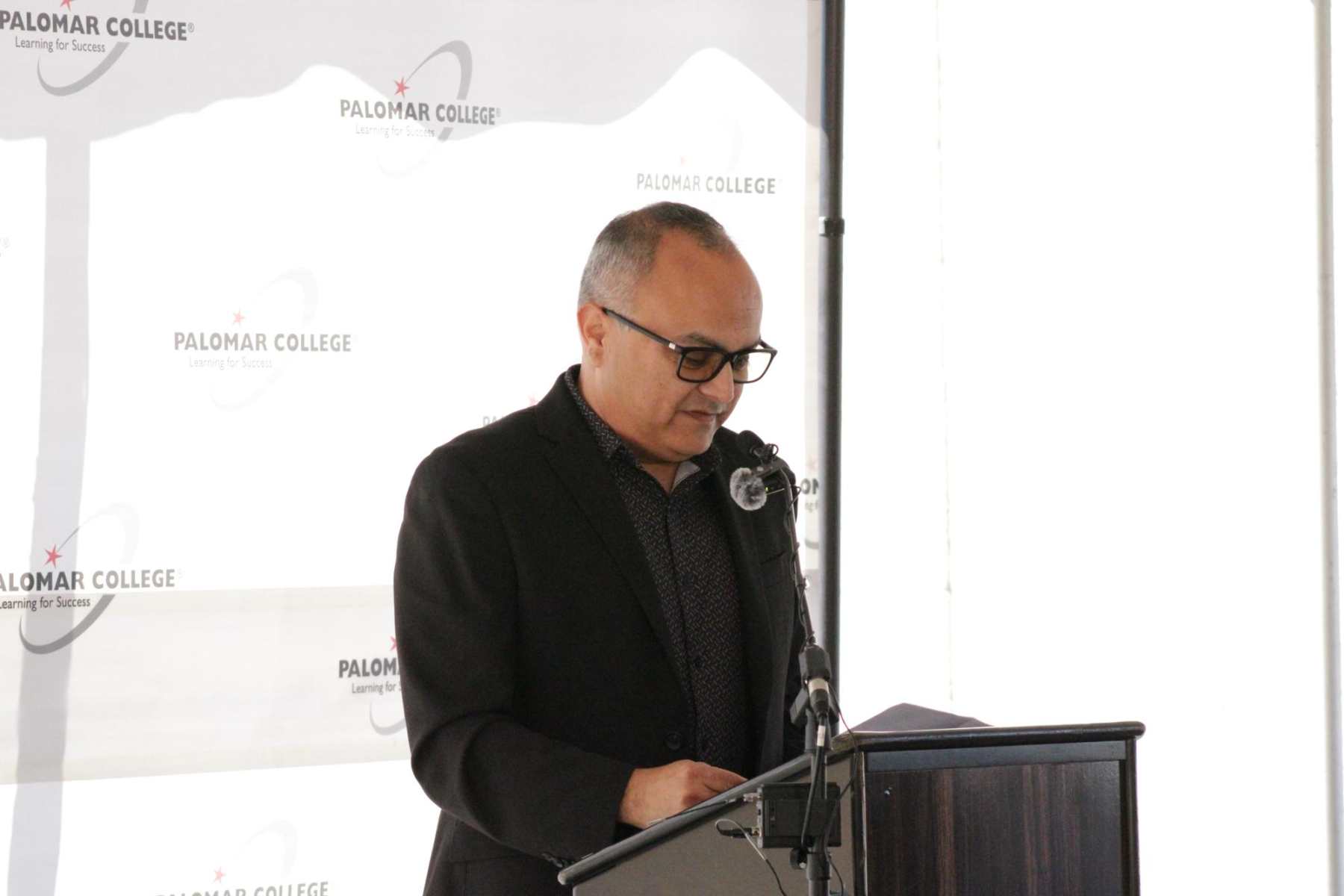 Nick Mata, Vice President of Student Services, reads the land acknowledgement at the beam signing ceremony at Palomar's Fallbrook campus on Oct.1. The Fallbrook campus land was formerly part of the Luiseño tribe.