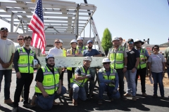 The construction crew poses with the beam before attaching it to be moved to the top of the structure at the beam signing ceremony at Palomar's Fallbrook campus on October 1.