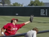 Palomar’s Anthony Balderas reaches into the Comet dugout to snag a foul ball as Palomar’s Sports Information Director Tom Saxe takes cover during the third inning against Orange Coast College. The Pirates defeated the Comets 3-0 at Euless Park in Fresno on May 24. Philip Farry / The Telescope