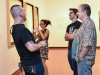 Clayton Llewellyn (far left), professor at MiraCosta College, catches up with artists and colleagues at the group exhibition “Sharp Contrast” at the Boehm Gallery, Palomar College, Thursday, Sept. 10, 2015. Xuchi Eggleton (left center) snaps a quick photo while show artist and husband Josh Eggleton (right center) and fellow exhibitor Robert Nelson (far right) converse with Llewellyn. Brandy Sebastian/The Telescope