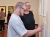 John Brouwer (left) shares with his mother Grace (right) what he enjoys about the featured artists work at the group exhibition “Sharp Contrast” at the Boehm Gallery, Palomar College, Thursday, Sept. 10, 2015. John, student at Palomar with mother, talks about how he loves the skulls that are part of Josh Eggleton’s work. Brandy Sebastian/The Telescope