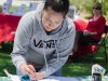 Palomar student Yesenia Mercado paints a shirt as part of the No More Campaign, a quest to increase national awareness of domestic violence and sexual assault as well as unite the efforts of both movements to end gender-based violence. This was just a part of Palomar College's Career Day held at the Student Union on April 27. Tracy Grassel/The Telescope