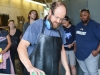 Michael Hernandez demonstrates polishing a paper weight for his Glass-Blowing 1 students in the campus studio on Tuesday Sept. 15. Different weight grits are used in polishing the bottom of hand blown glass in order to smooth out sharp surfaces. Brandy Sebastian/The Telescope