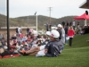 Spectators sit and watch the game on the new grassy knoll at the new ballpark on Jan. 27. Kyle Ester/ The Telescope