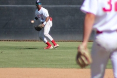Center fielder preparing to catch a ball, while another player wearing number 32 stands on the mound watching the play.