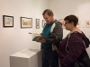 Paul Helling and Jessica Dugger look through a book illustrated by Lori Mitchell at the Annual Faculty Exhibition at the Boehm Gallery, Palomar College, San Marcos, December 2; 2015; Patty Hayton/The Telescope