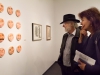 Palomar photography instructors Will Gibson and Melinda Finn stop to discuss the many faces of the paintings of emotions by Vicki Walsh at the Annual Faculty Exhibition at the Boehm Gallery, Palomar College, San Marcos. Dec. 2. Patty Hayton/The Telescope