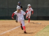 Palomar's Summer Evans (2) and Keilani "K.K." Fronda (11) score two points for the Comets after Kali Pugh (not seen) hit a double during their game against Santiago Canyon College, April 4. The Comets came out on top in their first of the double header games 5-2. Dirk Callum/The Telescope