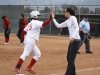 After hitting a home run, Lesha Hill #25 high fives her coach while she rounds third on March 11 against Mt. San Jacinto. Palomar beat MSJC at home 8-0. Seth Jones/The Telescope