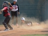 Palomar pitcher Moriah Lopez (#29) watches her teammate Brooke Huddleson (#4) slide safely into home plate as San Diego City College Knights catcher Kassandra Sanchez (#13) looks for another out opportunity during the March 30 game. Palomar won 9-0 ending the game in the 5th inning. Tracy Grassel/The Telescope