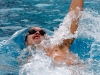 Palomar's Neal Gorman swims the 100-yard backstroke during the meet against Grossmont at the Wallace Memorial Pool on April 8. Gorman placed first with a time of 56.85. Coleen Burnham/The Telescope