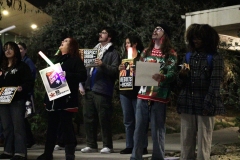 Students, staff, and faculty move to the side of the library and chant as they look up at the room where the Governing Board meeting is taking place on Dec 16, 2025, at Palomar College.
