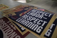 "Respect labor, respect learning" signs are set up on the tables outside the library.