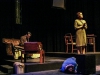 Laura Wingfield (bottom right, performed by Abby Fields) huddles on the gorund while herover bearing mother Amanda (far right, performed by Heidi Bridges) argues with her son Tom about his nightly escapades to "the movies," in the performance ofThe Glass Menagerie by Tennessee Williams at Palomar College. Lucas Spenser/Telescope.