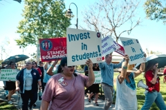 March in March attendees holding up their signs while walking around the San Marcos campus on March 12.
