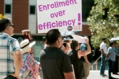 March in March attende holding up a sign high up during the March 12 rally at the San Marcos campus.