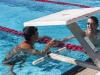 Alex Dillingham (upper right), of Grossmont College's men's swim team, congratulates Max Becerra (lower left), of Palomar College's men's team, after he wins the 200 Yard Breast event at the Wallace Memorial Pool March 14, 2014. Lucas Spenser/Telescope 2014.