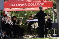 A group of palomar students performs "America the Beautiful" including instruments like the trumpet, French horn, trombone, tuba, and percussion.