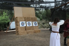 A festival attendee draws back an arrow as she prepares to fire at a target at the Vista Viking Festival archery range on Sept. 21, 2025. There were also spear and axe-throwing ranges. Photo credit: Tanner Hayes