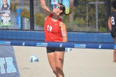 Reese Maffitt (#13) jumps to spike a ball over the net during a match with San Diego City on March 27 at MiraCosta College. 