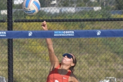 Kiana Merrill (#3) jumps to hit a ball over the net with her knuckle during a match against San Diego City on March 27 at MiraCosta college. 