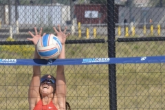 Annie Cummings (#7) jumps to block an oncoming ball during a match against San Diego City on March 27 at MiraCosta College. 