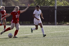 Lizzy Cook (#21) kicks the ball, scoring a goal during the first half of the game against the East La Huskies. Photo credit: Griselda Garcia