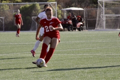 Keela Farnum (#29) passes the ball to a teammate as she gains possession of the ball away from the opposing team. Farnum scores a goal during the second half of the game, putting palomar at 7-2. Photo credit: Griselda Garcia