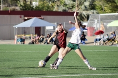 Palomar's Lizzy Cook (#25) in black, attempts to pass the ball while Grossmont's Allie Huntsman (#15) in white, blocks the pass.