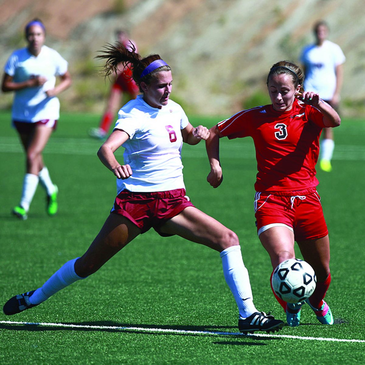 Palomar's Brianna Boretto eyes the ball as a Saddleback defender attempts to cut off a play at Minkoff Field (Stephen Davis/The Telescope)