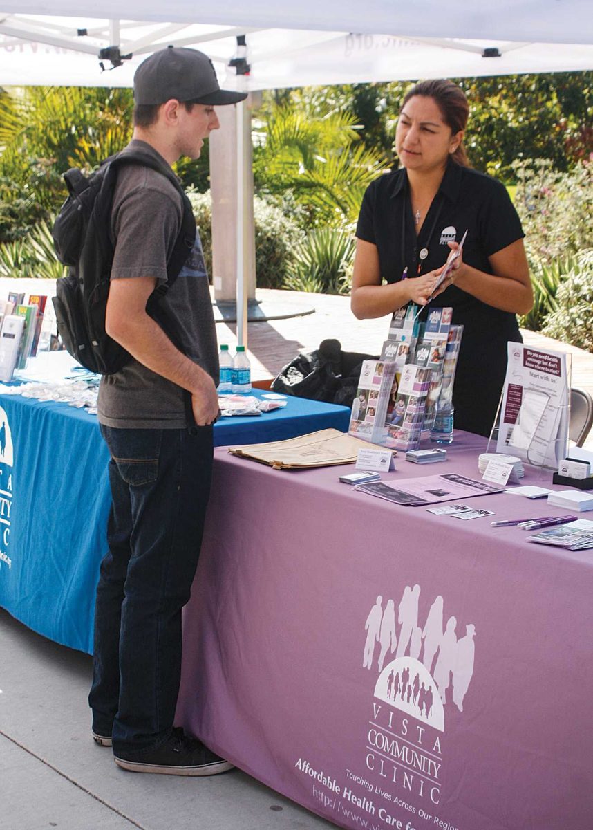 Monday, Oct. 21, 2013. Jessica Garcia, a representative from Vista Community Clinic, informs Andrew Smith, an 18 year old freshman, about health and the importance of physicals. Although Andrew’s educational goals to become an aerospace engineer, he also understands health plays an important roll in life. (Harim Arjon/The Telescope)