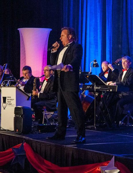 November 16, 2013. Russ Stolnack a.k.a Russ T. Nailz, MC of Saturday night's fundraising event, bounds on stage singing his introduction in the Costa Del Sol of the La Costa Resort. (Lucas Spenser/The Telescope)