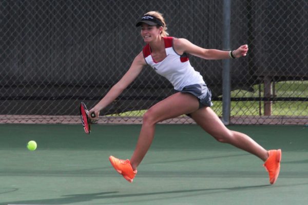 Palomar women's tennis player Remy Litrell jumps to hit a forehand against Irvine Valley College on Feb. 11, 2014 at Palomar's tennis courts. (Joe Davis/The Telescope)