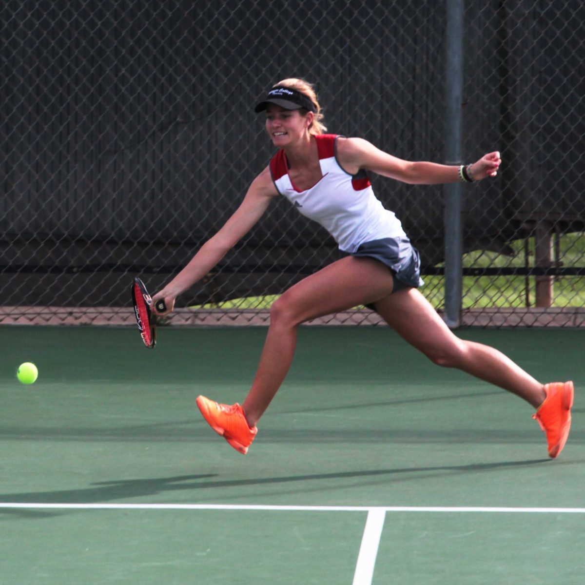 Palomar women's tennis player Remy Litrell jumps to hit a forehand against Irvine Valley College on Feb. 11, 2014 at Palomar's tennis courts. (Joe Davis/The Telescope)