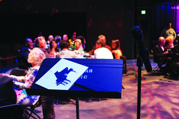A podium holding a sign picturing the Peter Gach Steinway Grand Piano Palomar College is interested in purchasing for the Howard Brubeck Theatre at The Festival fundraiser on April 12, 2014 (David Shrum/The Telescope)