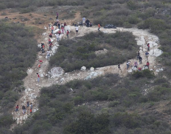 Volunteers go about the task of repainting the rocks that make up the Palomar "P" on April 25. (Stephen Davis/The Telescope)