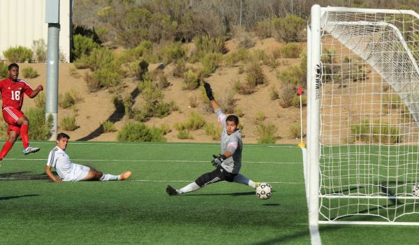Sept. 5, 2014 | Palomar College Forward #18 Eduardo Calleja sends the ball past NORCO College goalie Manny Hernandez in the 69th minute. Calleja scored the only goal in Friday's game at Minkoff Field. The Comets and Mustangs played to a 1-1 tie. (Philip Farry/The Telescope)